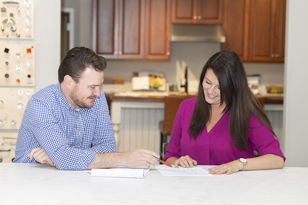 A couple discussing their kitchen remodel in their new home.